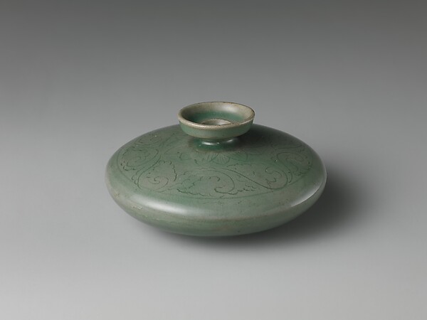 Oil bottle decorated with floral scrolls and lotus petals