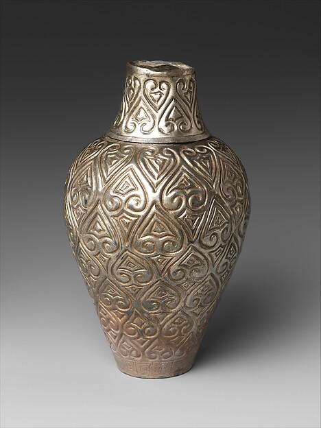 Covered bottle with cloud scrolls