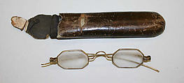 Eyeglasses, (a) glass, metal<br/>(b) imitation leather, American or European