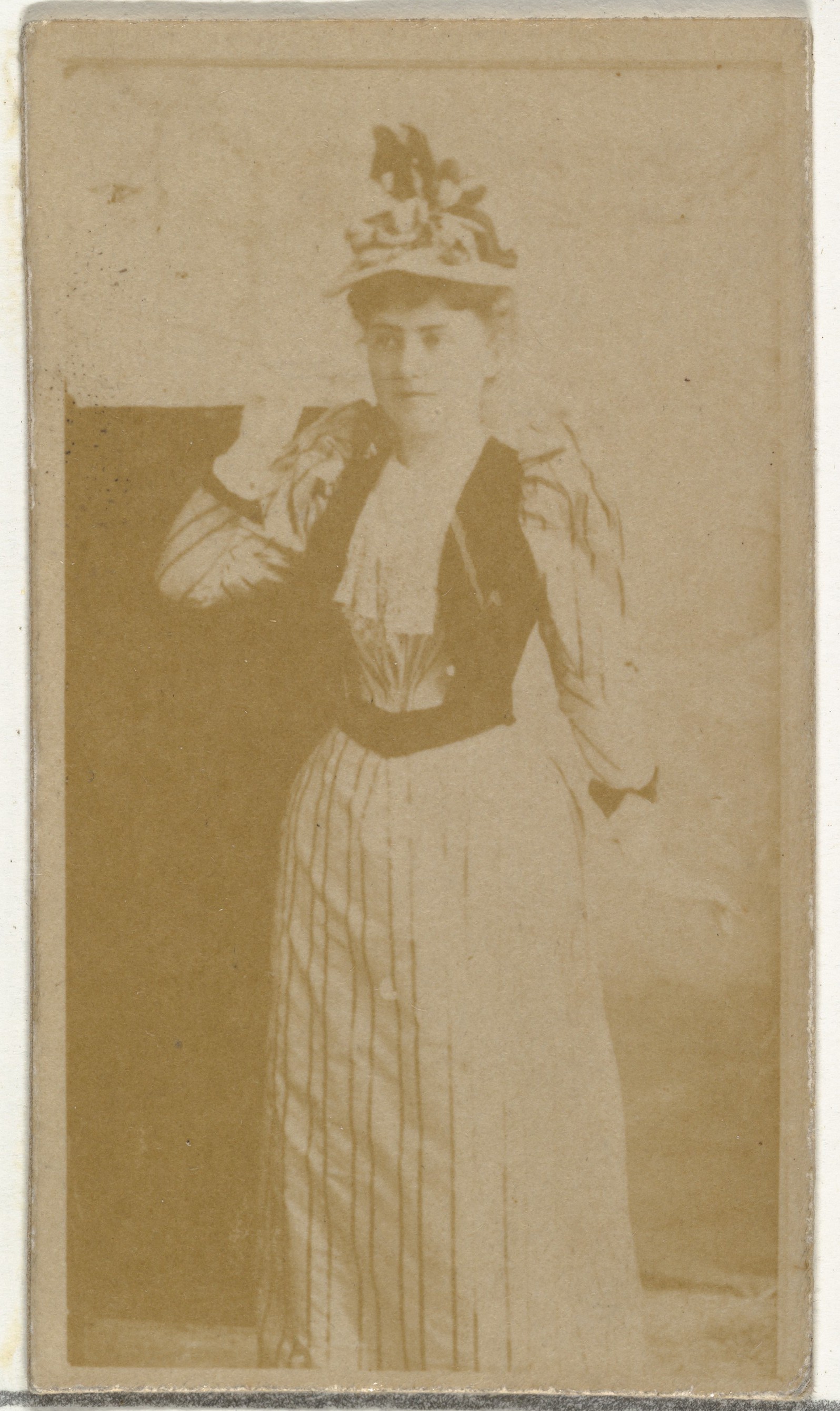 [Actress wearing dress with vertical striped pattern], from the Actors and Actresses series (N145-8) issued by Duke Sons & Co. to promote Duke Cigarettes
