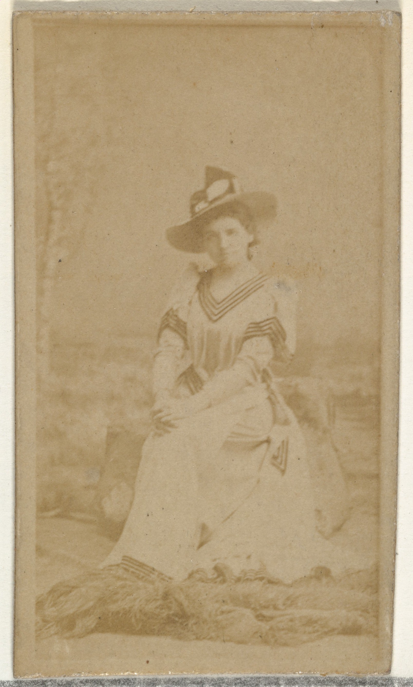 [Seated actress], from the Actors and Actresses series (N145-8) issued by Duke Sons & Co. to promote Duke Cigarettes
