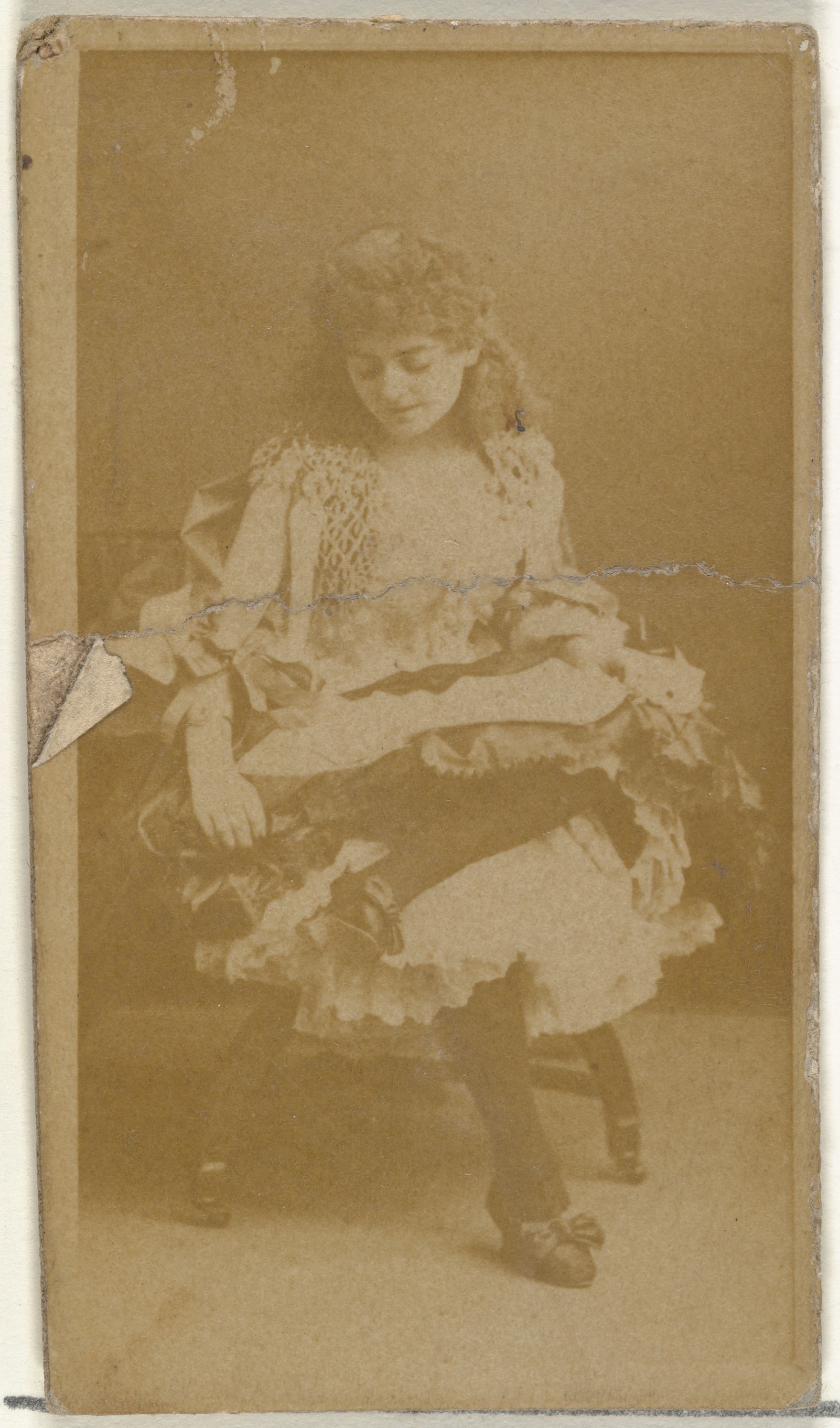 [Seated actress, looking down], from the Actors and Actresses series (N145-8) issued by Duke Sons & Co. to promote Duke Cigarettes