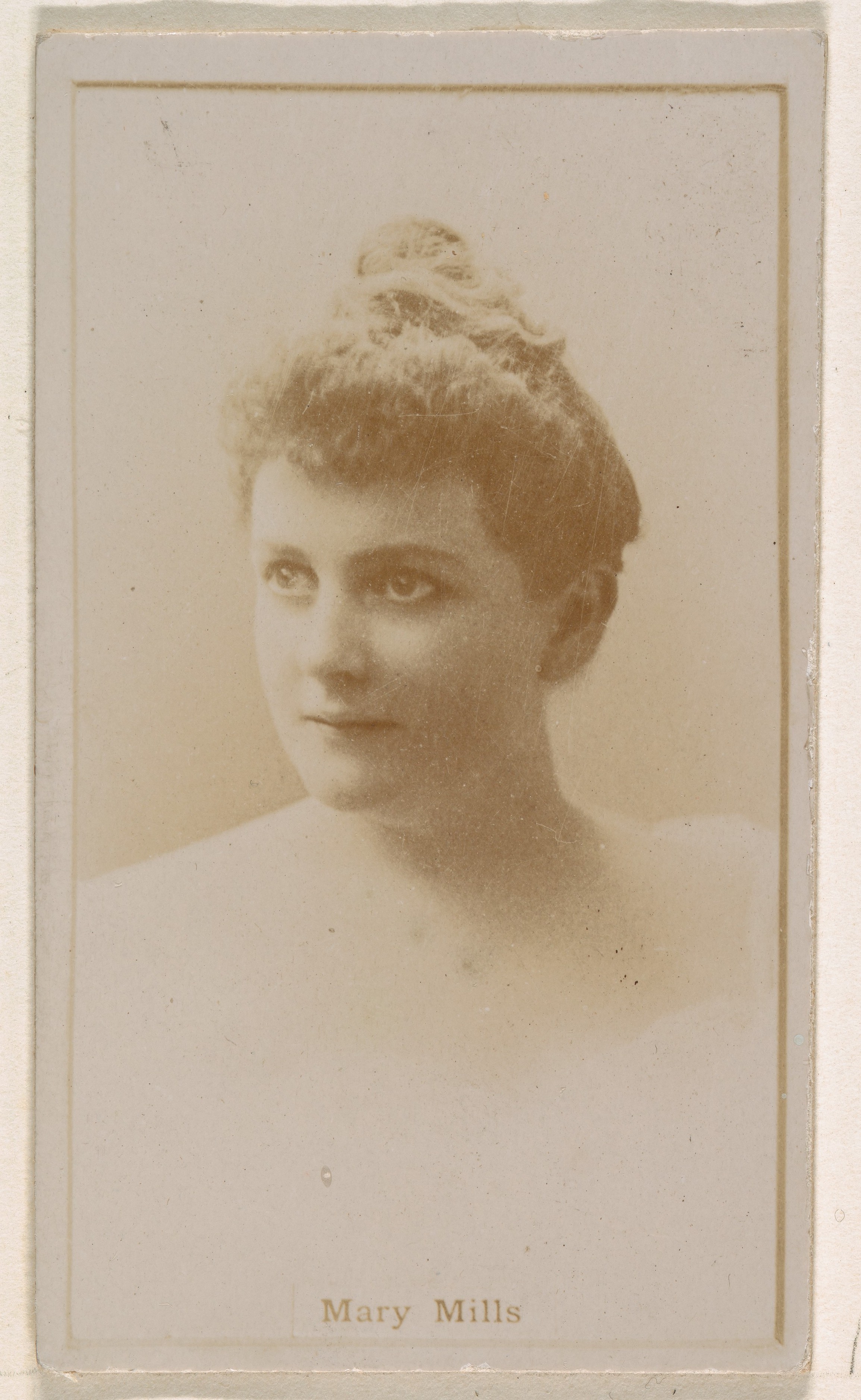 Mary Mills, from the Actresses series (N245) issued by Kinney Brothers to promote Sweet Caporal Cigarettes