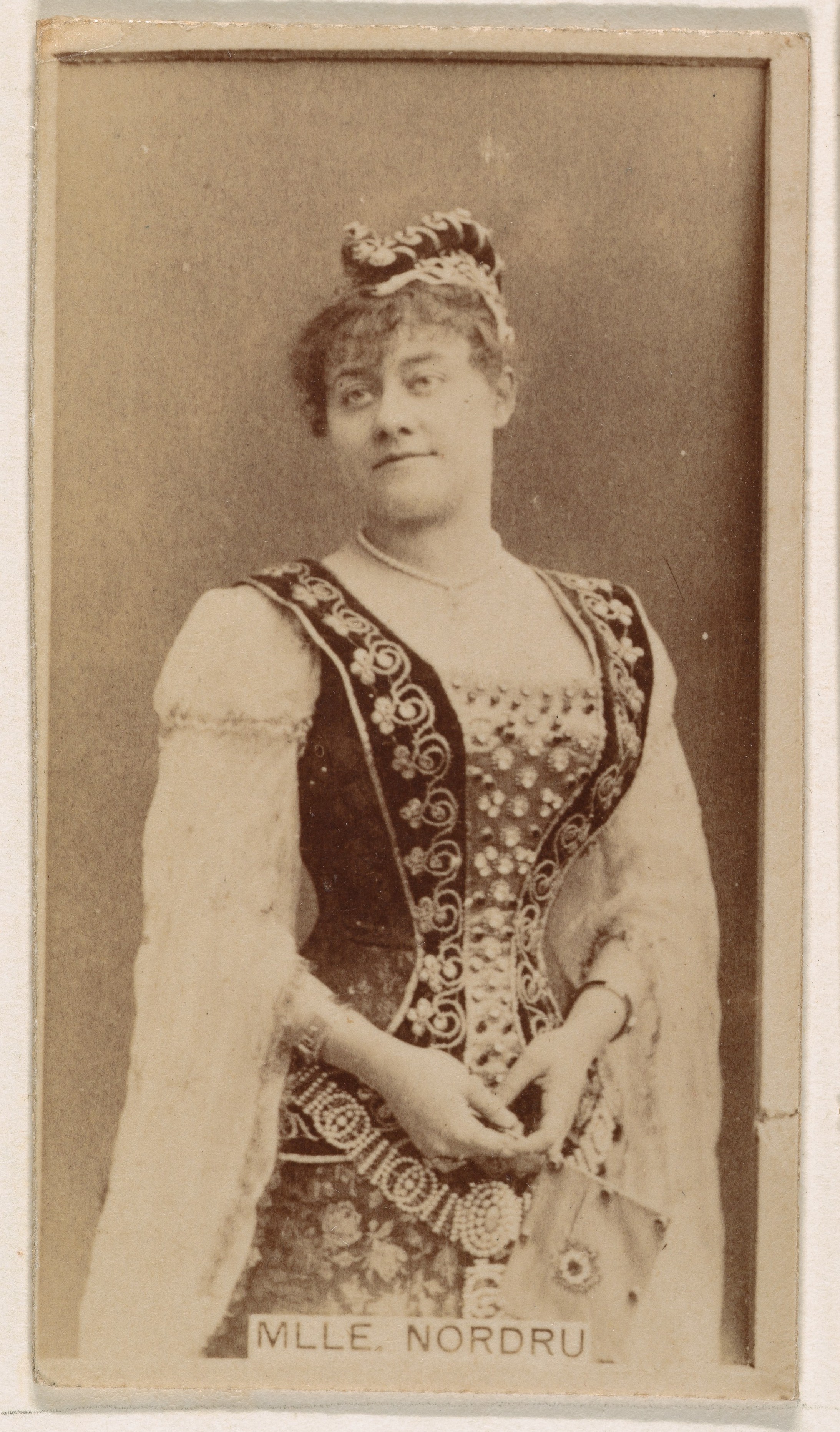 Mlle. Nordru, from the Actresses series (N245) issued by Kinney Brothers to promote Sweet Caporal Cigarettes