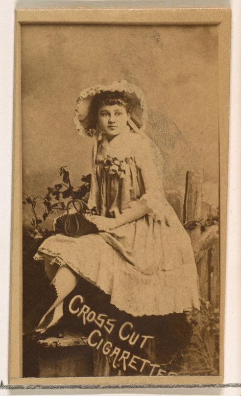 Seated actress holding bag, from the Actors and Actresses series (N145-1) issued by Duke Sons & Co. to promote Cross Cut Cigarettes