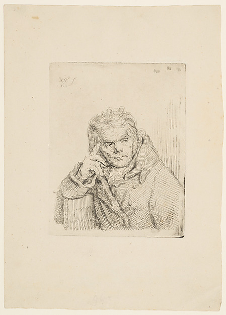 An old man in a fur coat sitting on a chair