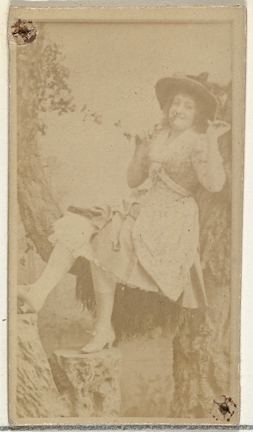 [Actress in studio reclining against prop trees], from the Actors and Actresses series (N145-8) issued by Duke Sons & Co. to promote Duke Cigarettes