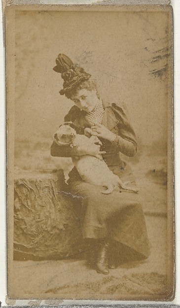 [Actress cradling small dog], from the Actors and Actresses series (N145-8) issued by Duke Sons & Co. to promote Duke Cigarettes