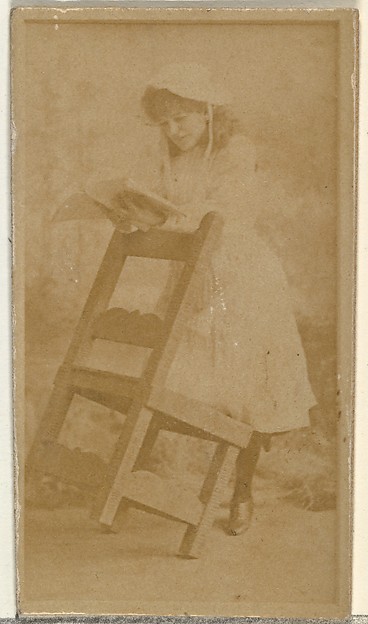 [Actress reading book while leaning on chair], from the Actors and Actresses series (N145-8) issued by Duke Sons & Co. to promote Duke Cigarettes