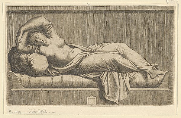 Cleopatra, partly naked laying on a bed