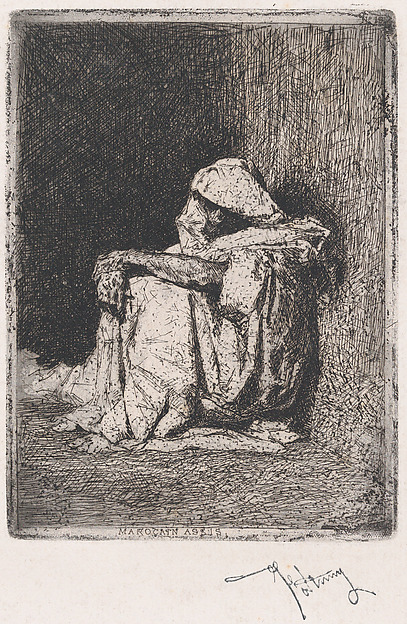 A Moroccan man seated on the ground
