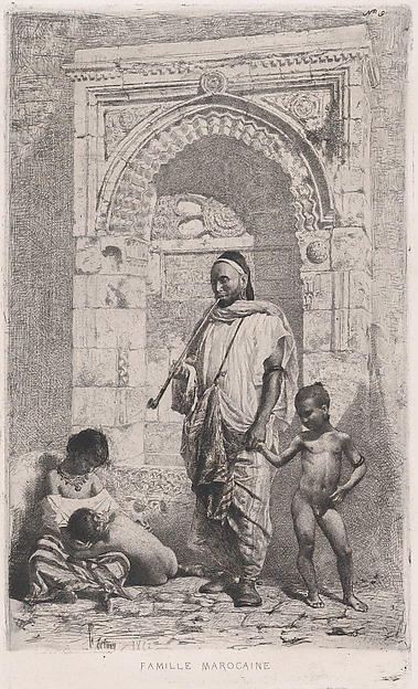 A Moroccan family in front of an arch, father standing, mother lower left on the ground holding a child
