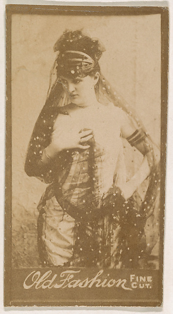 Actress wearing costume with lace head scarf, from the Actresses series (N664) promoting Old Fashion Fine Cut Tobacco
