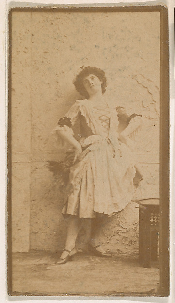 Actress leaning against wall, from the Actresses series (N664) promoting Old Fashion Fine Cut Tobacco