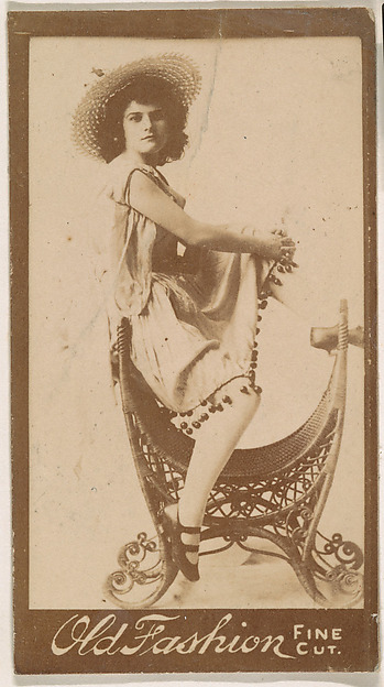Actress perched on elaborate chair, from the Actresses series (N664) promoting Old Fashion Fine Cut Tobacco