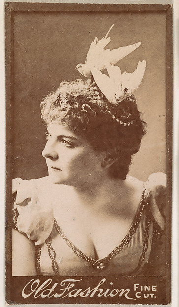 Actress wearing feathered headpiece, from the Actresses series (N664) promoting Old Fashion Fine Cut Tobacco
