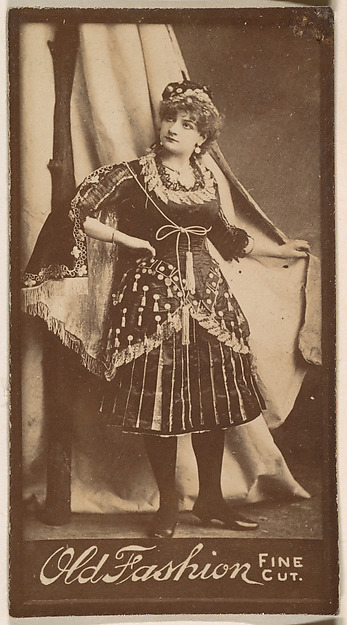 Actress holding studio curtain, from the Actresses series (N664) promoting Old Fashion Fine Cut Tobacco