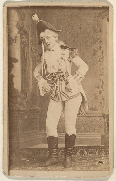 Actress wearing military costume standing with hands on hips, from the Actresses series (N668)