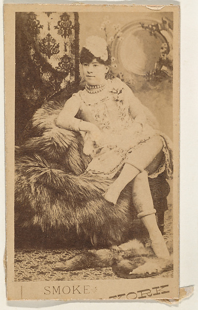 Actress lounging on fur throw, from the series Actresses (N674), promoting New York Dandies