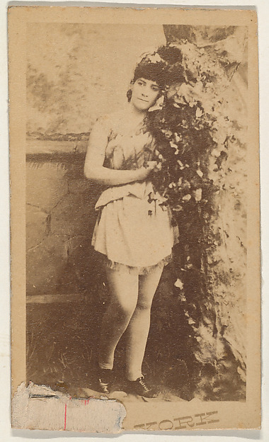 Actress leaning on ivy-covered prop tree, from the series Actresses (N674), promoting New York Dandies