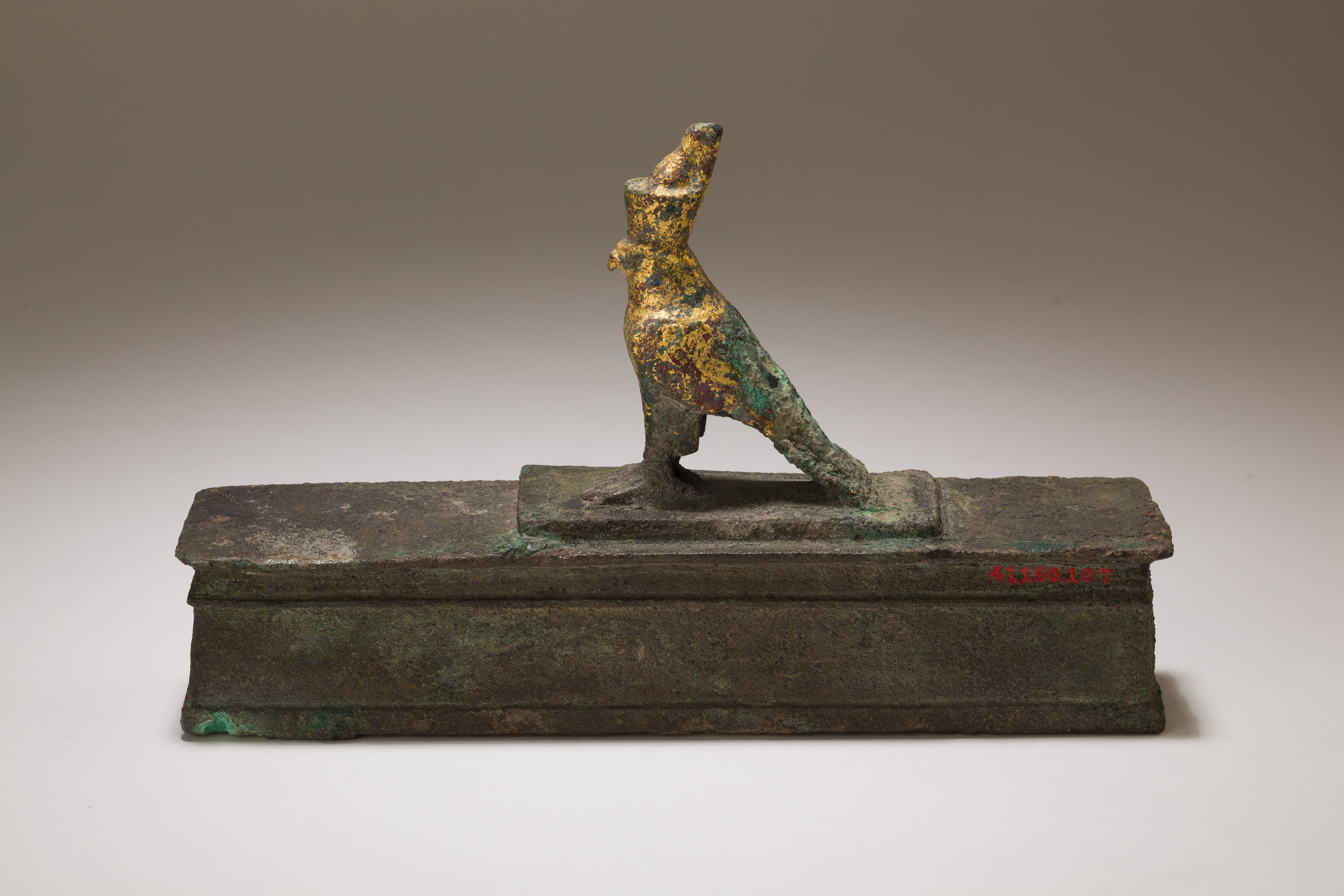 Falcon in double crown surmounting a shrine shaped box for an animal ...
