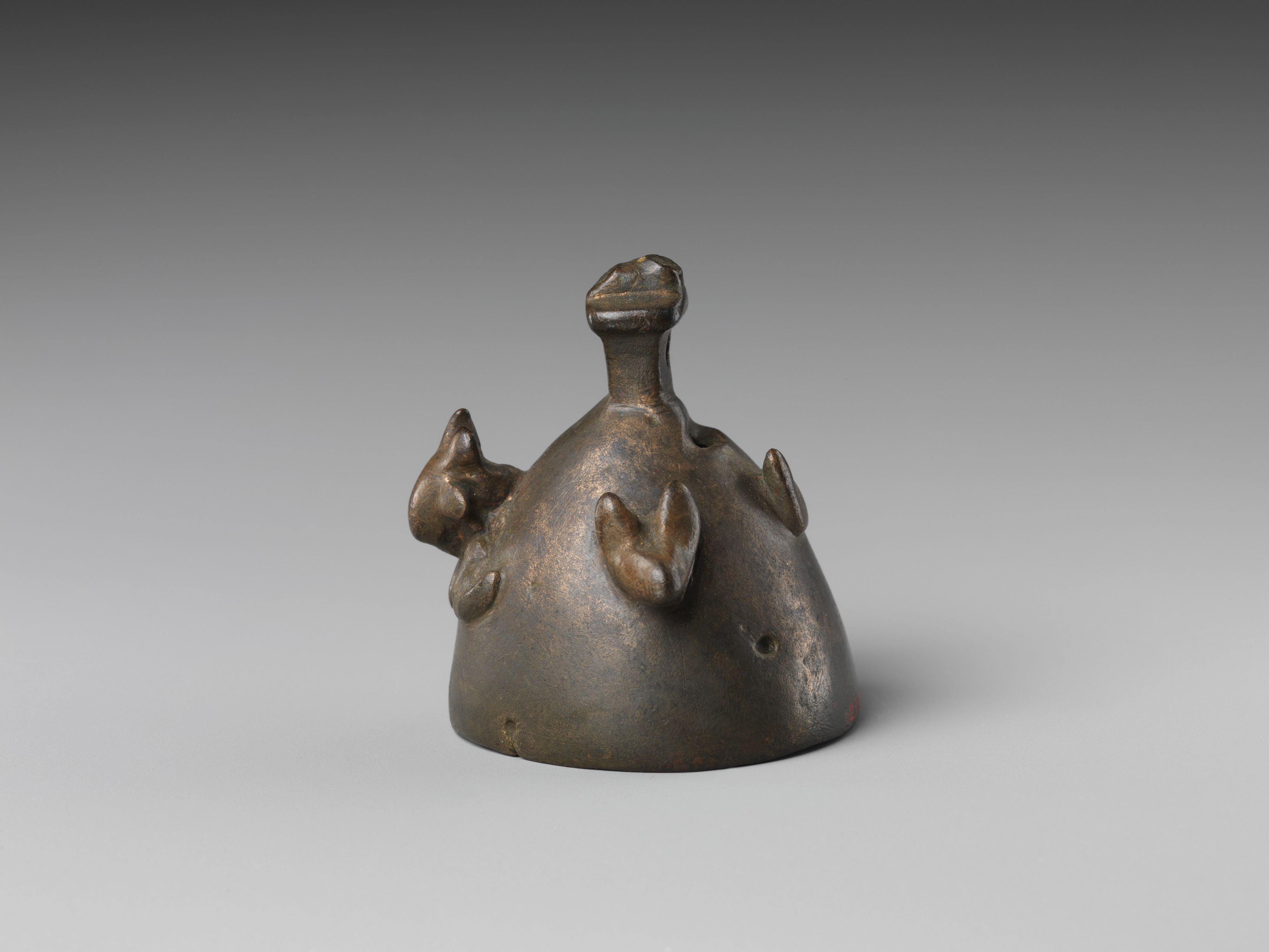 Bell with heads of a ram, a jackal, and a bovine wearing a yoke ending ...