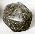 Twenty-sided die (icosahedron) with faces inscribed with Greek letters, Serpentinite