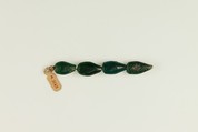 String of 4 pear-shaped beads, Translucent green glass