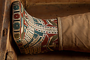 Mummy of Tasheriteniset with mummy mask and other cartonnage elements, also with garland of plants, Mummified human body, linen, mummification material, painted and gilded cartonnage, plant remains