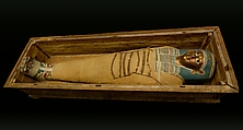 Mummy of Tasheriteniset with mummy mask and other cartonnage elements, also with garland of plants, Mummified human body, linen, mummification material, painted and gilded cartonnage, plant remains