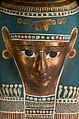 Mummy of Tasheriteniset with mummy mask and other cartonnage elements, also with garland of plants, Mummified human body, linen, mummification material, painted and gilded cartonnage, plant remains