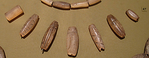 Group of 7 Beads: 1 Cylindrical (16.7.64); 1 Ovoid (16.7.59a); 5 Coleoptera beetles (16.7.59b–f), Bone (mineralized)