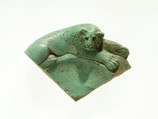 Fragment of a dish with a lion reclining on the rim, Faience