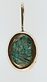 A modern pendant setting holding an inscribed scarab, Glazed steatite, gold