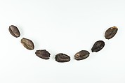 Seven beads in the shape of cowrie shells, Silver