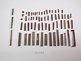 Inlays from shrine: box of red bars, Glass