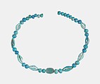 String of  ball beads, cowrie-styled beads, and a scarab, Faience, glazed steatite