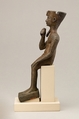 Seated Harpokrates with the crown of Amun, named as "Harpokrates-the-great, the eldest, the first of Amun", Cupreous metal, precious metal inlay