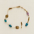 Bracelet with 4 wedjat eyes, 2 barrel beads, and 1 acacia bead, Linen, faience, gold, amethyst
