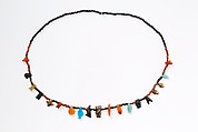Necklace with disc beads and amulets, Carnelian, gold, silver, faience, glass, yellow stone, tin