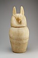 Canopic jar with a jackal-headed lid, Travertine (Egyptian alabaster)