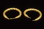 Spirally twisted tubular armlet with one goose-head terminal preserved, gold