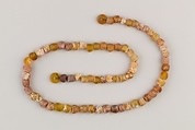 String of 70 beads, Amber glass