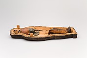Coffin and corn mummy with Osiris mask, coffin: wood, paint 
mummy: grain, sand, clay and/or soil, resin, linen bandages 
mask: wax