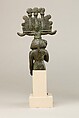 Child god in <em>nemes</em> and <em>hemhem</em> crown, Cupreous metal