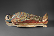 Falcon-form case containing a corn mummy, Painted gessoed wood; mummy: linen, resin, fiber