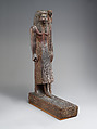 Statuette of Kary carrying a standard of Horus, Wood