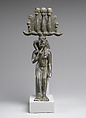 Child god in <em>nemes</em> and <em>hemhem</em> crown, Cupreous metal