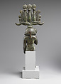 Child god in <em>nemes</em> and <em>hemhem</em> crown, Cupreous metal