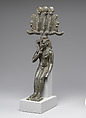 Child god in <em>nemes</em> and <em>hemhem</em> crown, Cupreous metal